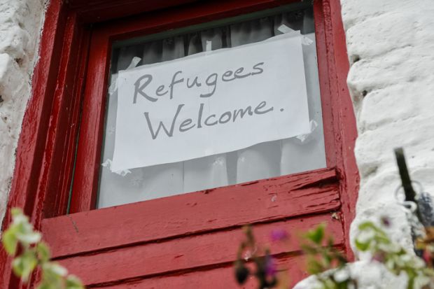 Sign on a window saying Refugees Welcome