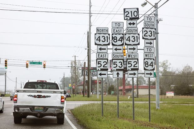 A confusing mass of signs by a US road A confusing mass of signs by a US road