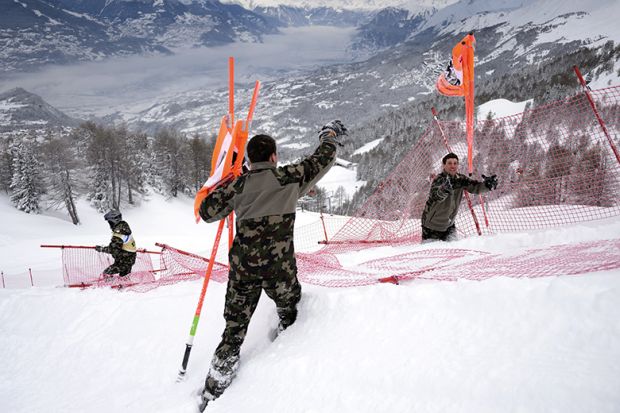 Swiss soldats remove gates at the FIS Alpine Skiing World Cup in Crans-Montana, 2016 Swiss soldats remove gates at the FIS Alpine Skiing World Cup in Crans-Montana, 2016, illustrating new code of academic conduct