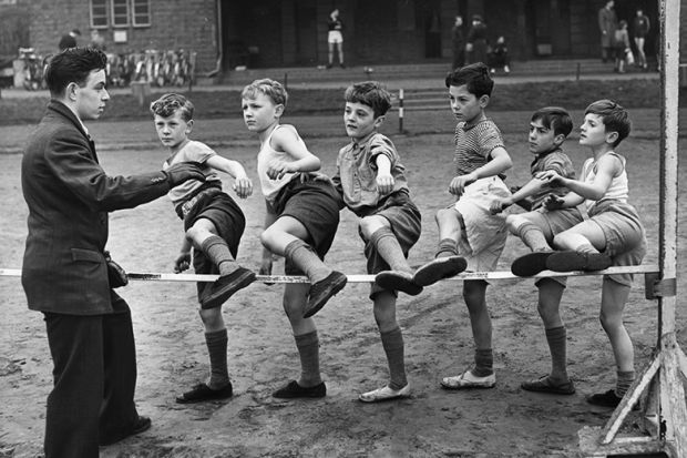 Cubs from London train at Ladywell Park for their athletes Proficiency Badge, by stepping over a low high jump, 1955. To illustrate contextual offers / lower entry requirements. Cubs from London train at Ladywell Park for their athletes Proficiency Badge, by stepping over a low high jump, 1955. To illustrate contextual offers / lower entry requirements.