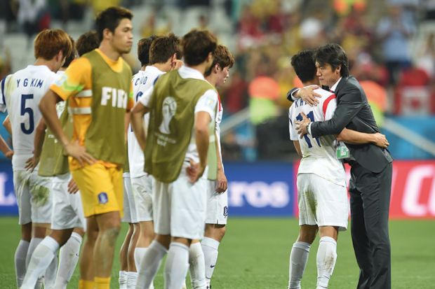 South Koreas football coach hugs one player South Koreas football coach hugs one player