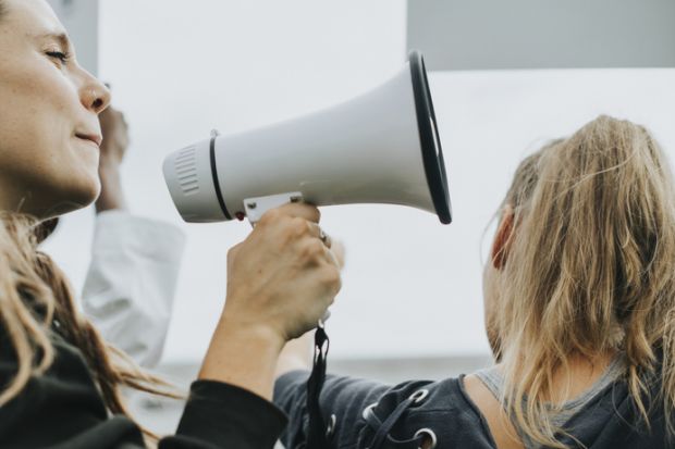 Speaking into megaphone