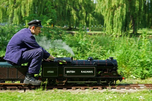 Miniature steam train and driver St Neots, Cambridgeshire, England - May 05, 2022 Miniature Steam train and driver in the park.