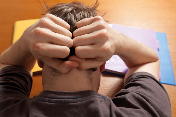 Stressed male student suffering from anxiety Stressed male student suffering from anxiety