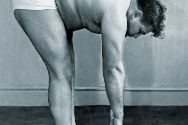 Man stretching to touch his toes Man stretching to touch his toes