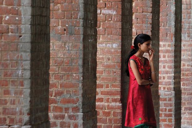 Student waiting in corridor, University of Delhi Student waiting in corridor, University of Delhi