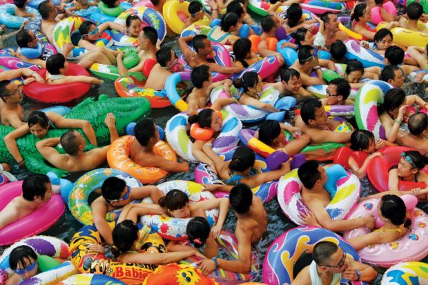 Swimmers in artificial wave pool, Suining, Sichuan province, China Swimmers in artificial wave pool, Suining, Sichuan province, China