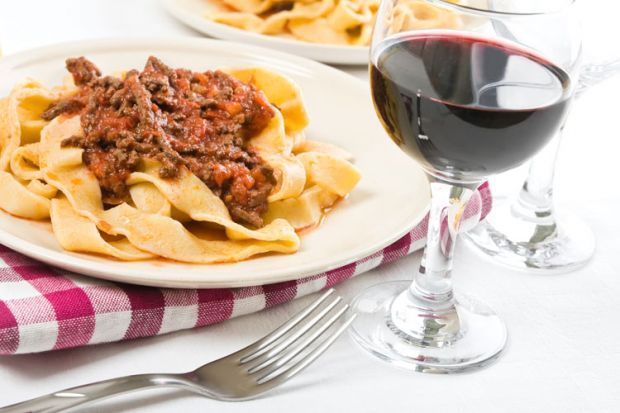 Tagliatelle with bolognese sauce and glass of red wine Tagliatelle with bolognese sauce and glass of red wine