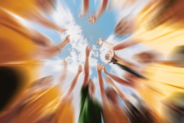 Members of a sports team reach out to each other Members of a sports team reach out to each other