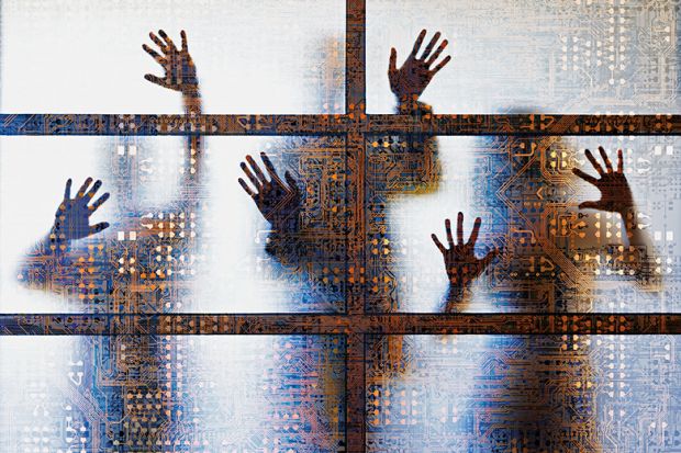 People outlined behind a screen showing computer circuitry