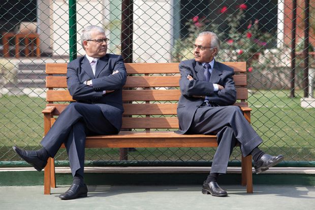Two men facing each other on a bench
