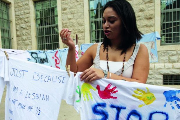 lady_hanging washing_tshirts_washingline_pegs