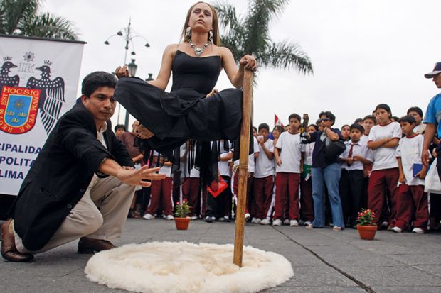 Illusionist appearing to levitate
