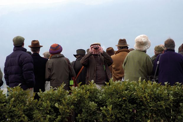 Man looking the other way at horse race