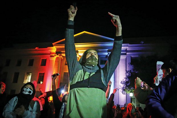 People protest on February 1, 2017 in Berkeley, California. A speech by controversial Breitbart writer Milo Yiannopoulos, who was scheduled to speak at UC Berkeley, was cancelled after protesters and police engaged in violent skirmishes