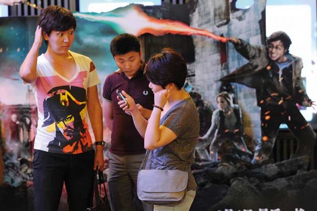 Chinese people in front of a Harry Potter backdrop