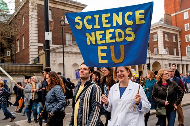 A protester holds a "Science needs EU" banner on a march and rally organised by the pro-European People's Vote campaign for a second EU referendum in Parliament Square, central London on March 23, 2019 A protester holds a "Science needs EU" banner on a march and rally organised by the pro-European People's Vote campaign for a second EU referendum in Parliament Square, central London on March 23, 2019