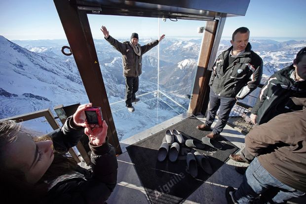 People at the 'Step into the Void' installation in the French Alps, France