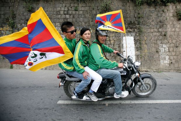 Exiled Tibetan protesters riding on motorbike