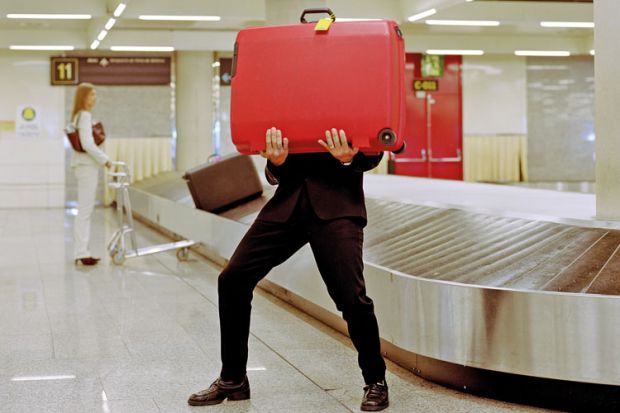 Man holding suitcase in airport