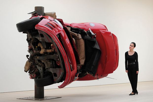 Woman standing next to art installation