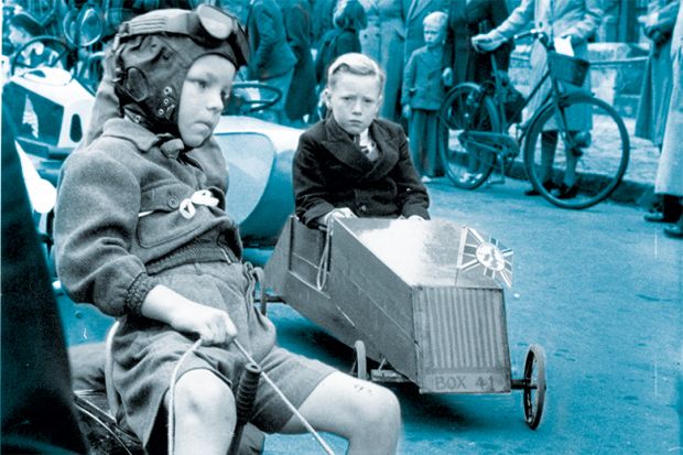 Young competitors make their way to the starting point on an assortment of vehicles.