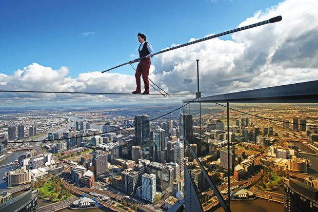 High-wire artist Kane Petersen successfully walks a tightrope 300 metres above the ground at Eureka Skydeck in Melbourne, Australia. 