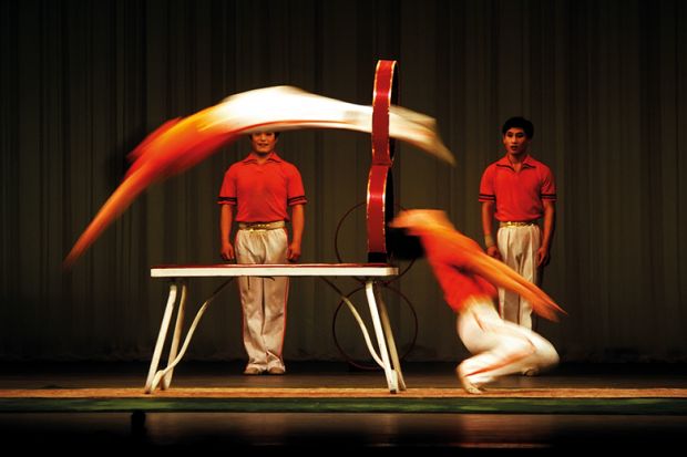 Acrobats jumping through hoops Acrobats jumping through hoops