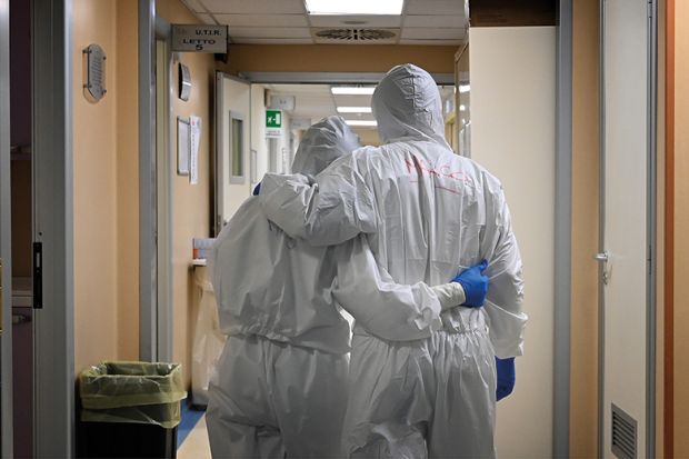 Doctor and nurse at the end of their shift in a corridor of the intensive care unit, treating COVID-19 patients. Italy. Doctor and nurse at the end of their shift in a corridor of the intensive care unit, treating COVID-19 patients. Italy.