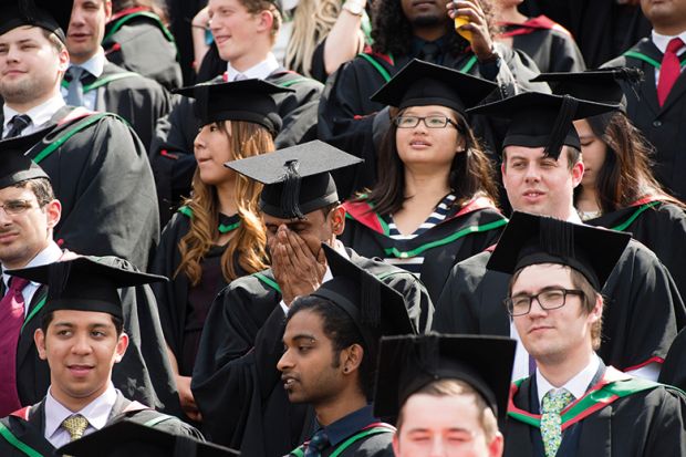 Graduating students in mortarboards Graduating students in mortarboards