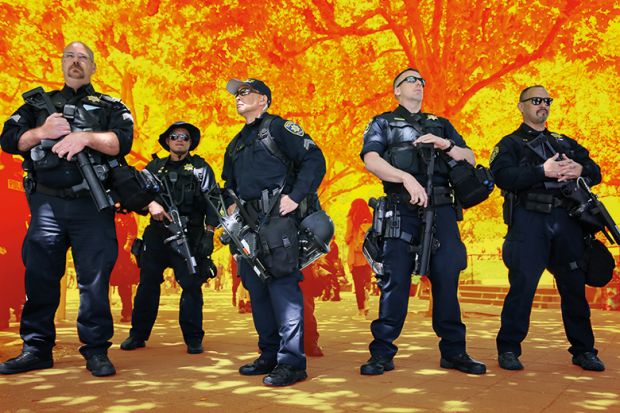 Police officers form a line on the edge of the UC Berkeley campus Police officers form a line on the edge of the UC Berkeley campus