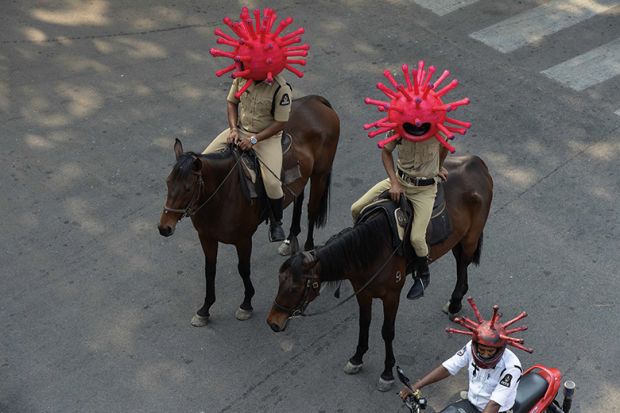 Police personnel wearing coronavirus-themed helmets ride on horses as they participate in a awareness campaign during a 21-day government-imposed nationwide lockdown as a preventive measure against the COVID-19 coronavirus. India Police personnel wearing coronavirus-themed helmets ride on horses as they participate in a awareness campaign during a 21-day government-imposed nationwide lockdown as a preventive measure against the COVID-19 coronavirus. India