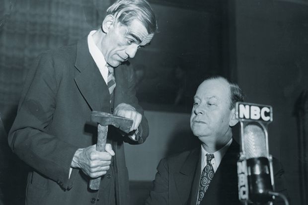 Man showing axe to another
