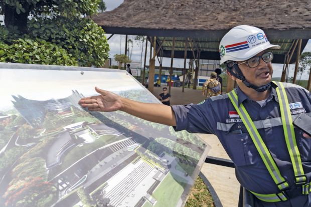 A worker shows an artist rendition of the country's new capital Nusantara A worker shows an artist rendition of the country's new capital Nusantara to illustrate Doubts over higher education vision for Indonesia’s new capital