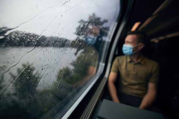Passenger on a train wearing a face mask Passenger on a train wearing a face mask