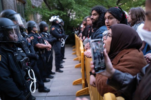 University police are confronted by protestors on the University of Chicago campus while they break up a pro-Palestinian encampment to illustrate The problem of US campus policing