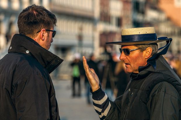 Two male gondoliers speaking, Piazza San Marco, Venice, Italy Two male gondoliers speaking, Piazza San Marco, Venice, Italy
