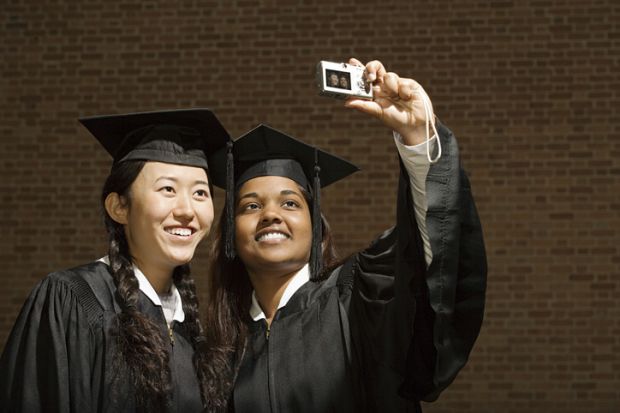 Two female graduates taking a photograph