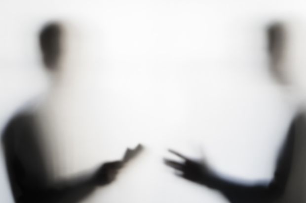 Two men negotiating behind curtain