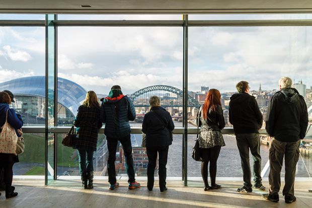 People looking out the window of the Baltic at the city view of Newcastle upon Tyne People looking out the window of the Baltic at the city view of Newcastle upon Tyne