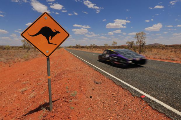 The Sunswift car 'Violet' from Australia passes a kangaroo sign to illustrate Oceania sets pace in sustainability race