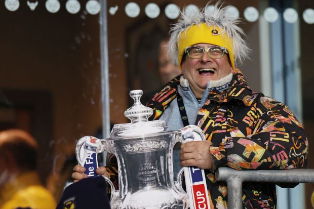 Oxford United fan with a replica Cup Trophy to illustrate Create PhD databases to flush out fraudsters, universities told