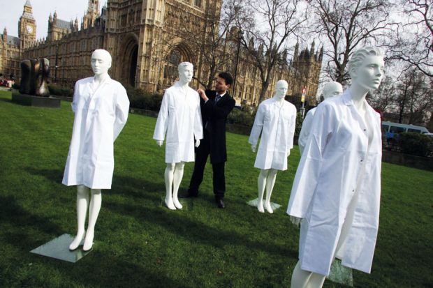 Group of unused laboratory coats and mannequins at Westminster, Central London to highlight the fact that the Government is cutting funding from the national research budget to illustrate Anger as social sciences lose cash to STEM under REF rule change