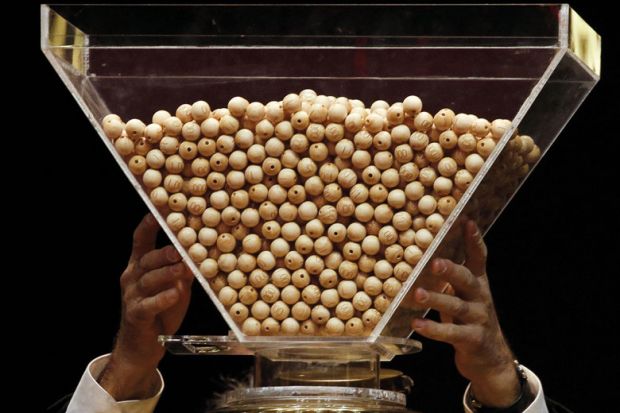 Lottery balls are dropped into a rotating drum before the start Lottery balls are dropped into a rotating drum before the start to illustrate Netherlands plots cautious return to degree admission lotteries