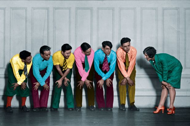 Rehearsal of a show of a group in a line holding their knees to illustrate For academia and policymakers, relationships are key to impact