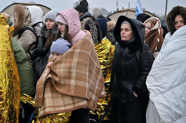 Refugees wrapped in blankets stand in line in the cold as they wait to be transferred to a train station after crossing the Ukrainian border Refugees wrapped in blankets stand in line in the cold as they wait to be transferred to a train station after crossing the Ukrainian border to illustrate Five universities join forces to offer ‘wrap-around’ support to refugees