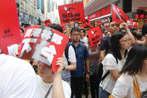 Demonstrators hold placards during the anti extradition march. Demonstrators hold placards during the anti extradition march to illustrate Concerns Hong Kong students’ union faces on campus
