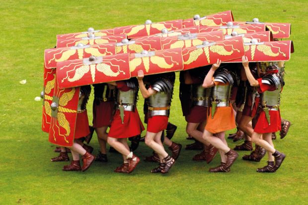 Ermine Street Guard demonstrate the tortoise defensive manoeuvre in display of fighting skills to illustrate OfS accused of lack of transparency over 30 standards probes