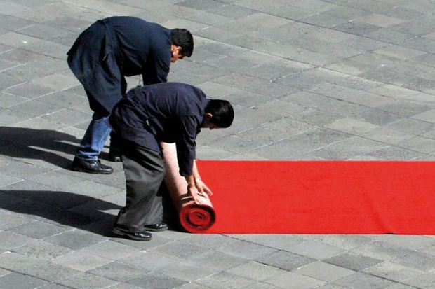 wo workers of the Mexican National Palace, roll a red carpet wo workers of the Mexican National Palace, roll a red carpet to illustrate Tec de Monterrey splashes out $100 million on top Western scholars