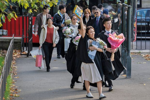 An Asian graduate from Imperial College London holds a Lego aircraft model to illustrate Public wary of growing overseas student numbers as views shift